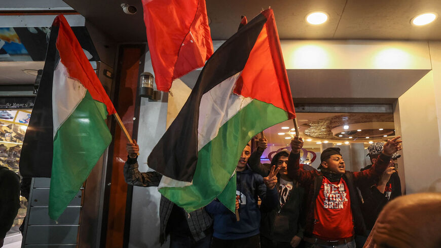 Palestinian supporters of the Popular Front for the Liberation of Palestine hold national flags during a rally to protest the meeting in Ramallah of the PLO Central Committee, Gaza City, Gaza Strip, Feb. 6, 2022.