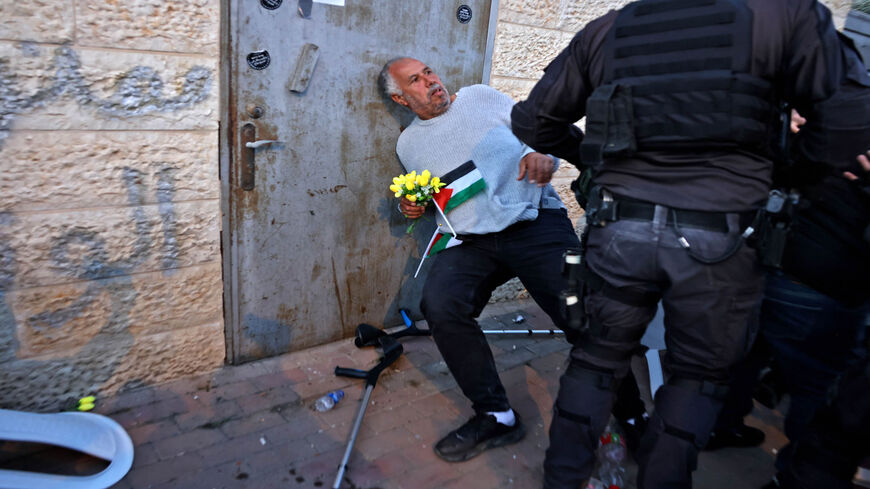 Israeli policemen scuffle with Palestinian Jerusalemite activist Mohammed Abu al-Hummus during a protest in Sheikh Jarrah neighborhood, in Israeli-annexed East Jerusalem, Feb. 18, 2022.