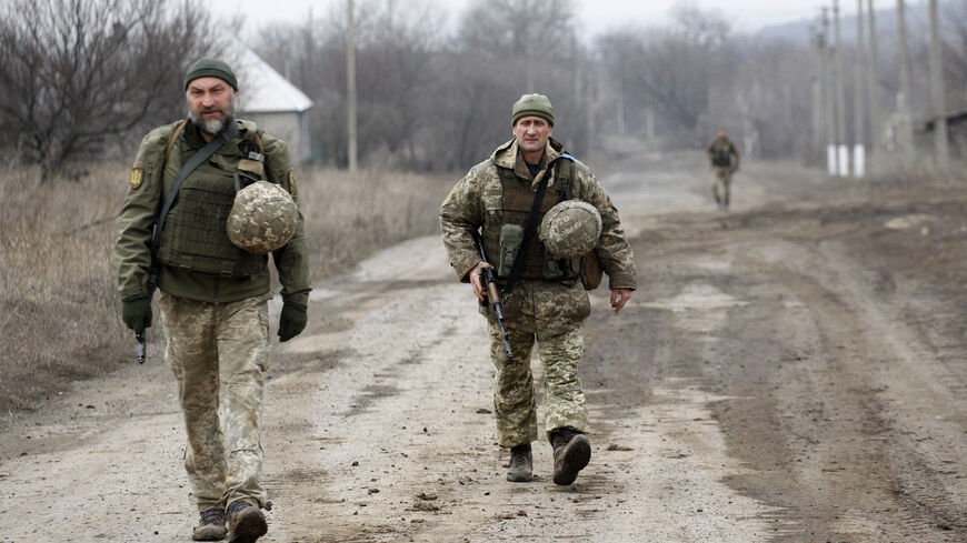 Ukrainian servicemen patrol in the settlement of Troitske in the Lugansk region near the front line with Russia-backed separatists on Feb. 22, 2022, a day after Russia recognised east Ukraine's separatist republics and ordered the Russian army to send troops there as "peacekeepers".  