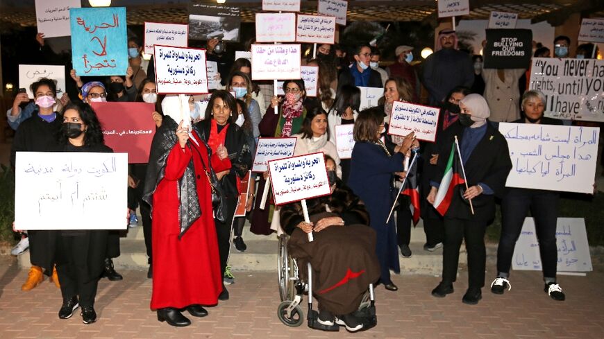 Women activists rally in support of their right to exercise activities, outside the National Assembly in Kuwait City, after a women's yoga retreat denounced as "indecent" was postponed