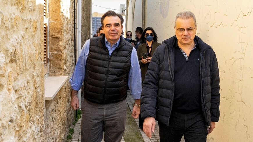 Cyprus' Interior Minister Nicos Nouris, on the right, shows European Commission Vice President Margaritis Schinas the divided capital of Nicosia, close to the UN-patrolled Green Line, on February 20, 2022