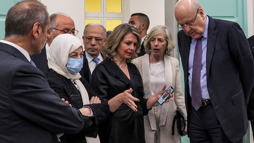 Lebanese Prime Minister Najib Mikati (R) and UNESCO’s Assistant Director-General for Education Stefania Giannini (2nd-R) listen to Maysoun Chehab (C), UNESCO's national education officer for Lebanon