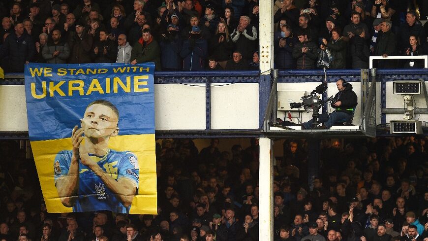 A Ukraine solidarity banner is hung from the stands at English club Everton's Goodison Park ground for its Premier League fixture against Manchester City on February 26