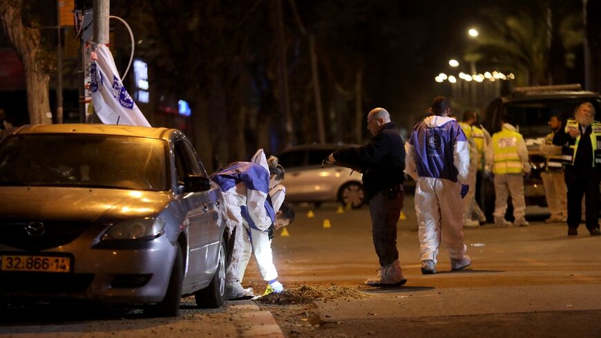 Israeli security forces gather at the site of an attack that left two Israeli police dead in the northern city of Hadera on March 27, 2022