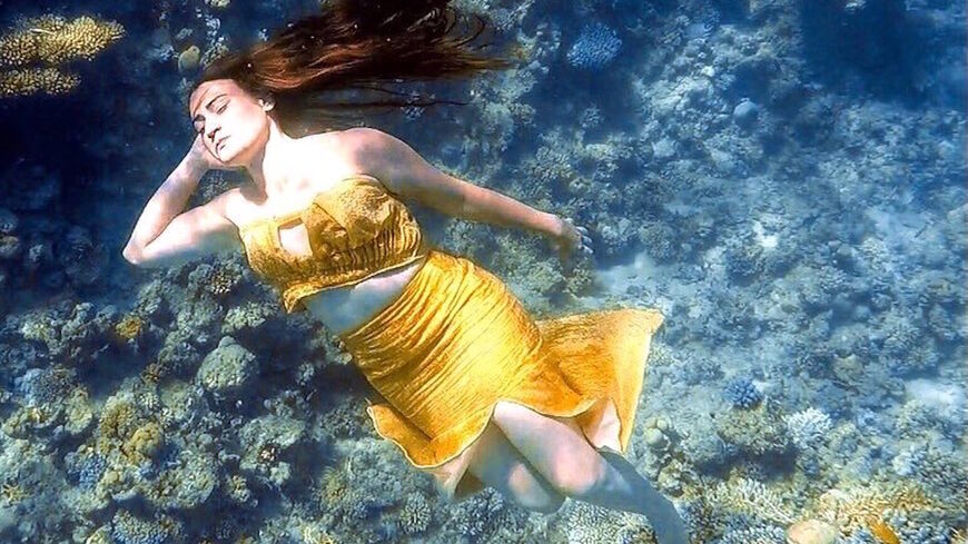 A model participates in the first underwater fashion show in Egypt.