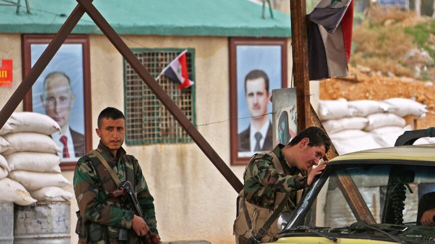 Syrian regime forces man a checkpoint during the evacuation of people from the rebel-held enclave of Eastern Ghouta through safe corridors announced by Russia in February 2018