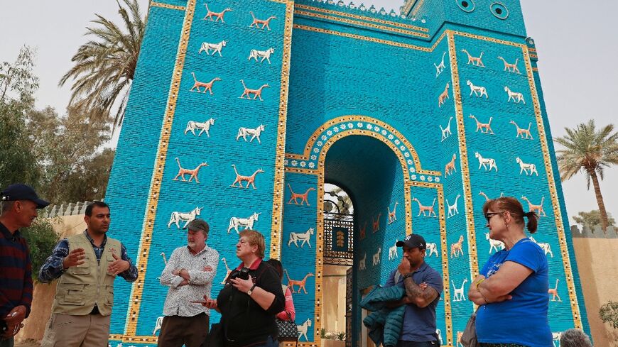 Foreign tourists visit the Ishtar Gate in the  ancient city of Babylon, some 100 km south of the Iraqi capital Baghdad