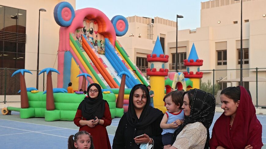 Afghan refugees gather in a playground at the Park View Villas in Qatar's capital Doha 