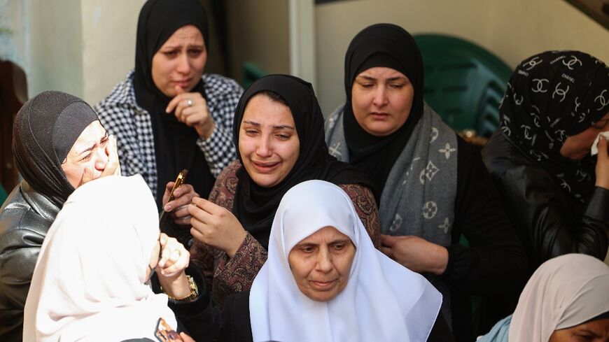 Women mourn a Palestinian man killed by Israeli forces during an arrest raid, at his funeral in Jenin in the occupied West Bank