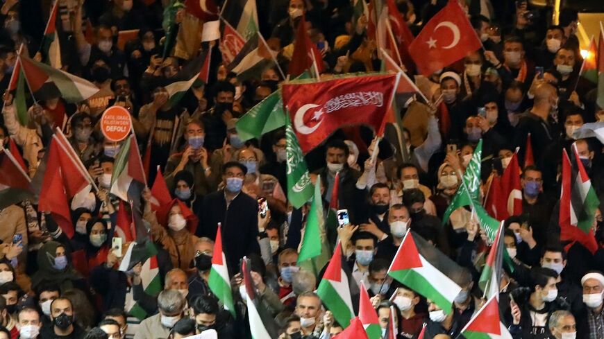Protesters hold Palestinian and Turkish national flags, as well as flags of the Islamist group Hamas, during a protest in Turkey against Israel's deadly air strikes on Gaza last May