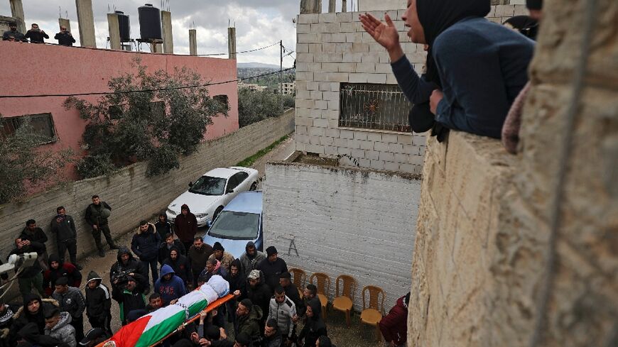 Mourners carry the body of 16-year-old Palestinian Nader Rayan who was killed by Israeli forces, during his funeral at the Balata camp near the northern city of Nablus