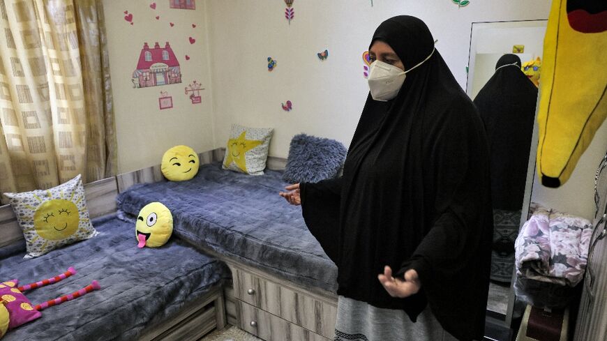 Umm Mohammed Iali shows the bedroom she has prepared for her granddaughters, who are held with their mother in Syria's Al-Hol camp