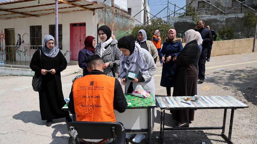 Palestinians registered to vote in the municipal elections in Beit Furik, east of the city of Nablus, as polls opened in towns and cities across the Israeli-occupied West Bank