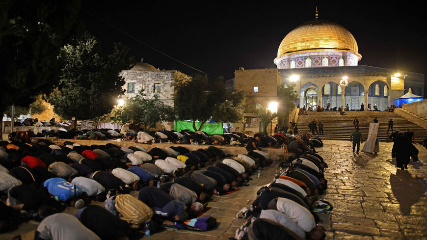 Palestinian devotees pray on Laylat al-Qadr (Night of Destiny) outside the Dome of the Rock at Al-Aqsa Mosque compound during the Muslim holy month of Ramadan, East Jerusalem, May 8, 2021.