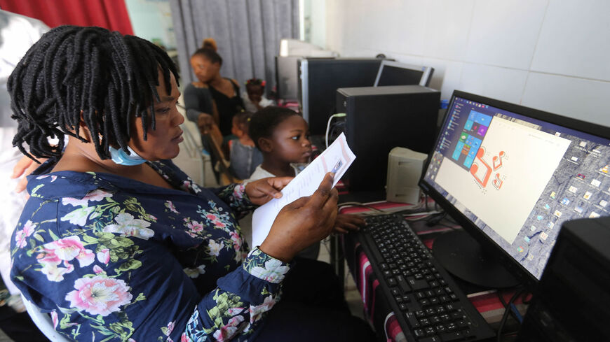 Sub-Saharan migrant women learn how to use a computer at a center run by the Organization for the Support of Migrants, Medenine, Tunisia, June 15, 2021.