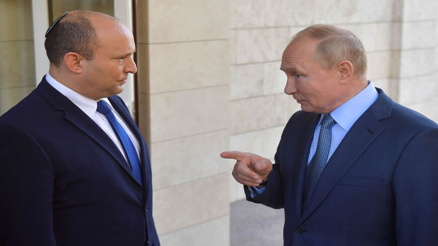 Russian President Vladimir Putin (R) speaks with Israeli Prime Minister Naftali Bennett during their meeting, in Sochi, Russia, Oct. 22, 2021.