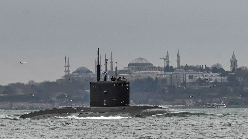 Russian navy's submarine Rostov-on-Don sails with a naval ensign of the Russian Federation through the Bosporus on the way to the Black Sea past the city of Istanbul, Turkey, Feb. 13, 2022.