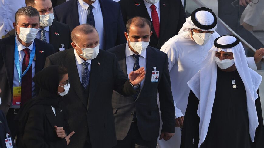 Turkish President Recep Tayyip Erdogan walks alongside UAE's Minister of Tolerance and Coexistence Sheikh Nahyan bin Mubarak al-Nahyan (R).