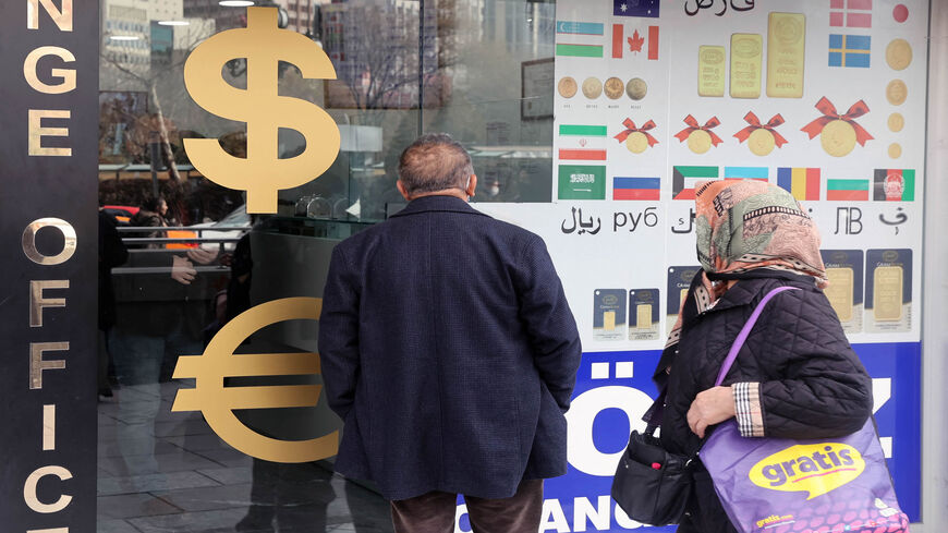 People look at exchange rates outside an exchange office, Ankara, Turkey, Feb. 23, 2022.