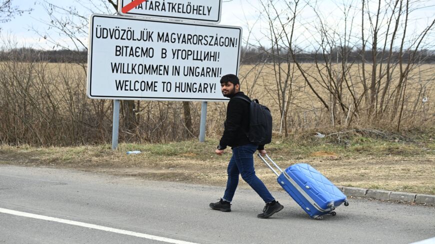 A university student crosses the border from Ukraine by foot in Barabas, Hungary, on Feb. 28, 2022.