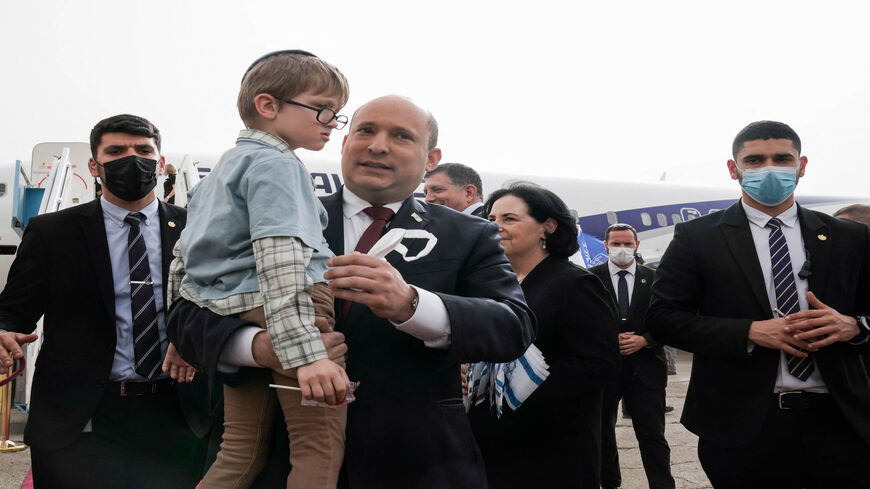 Israeli Prime Minister Naftali Bennett welcomes a group of orphans from the Alumim orphanage in the Ukrainian city of Zhytomyr, on arrival at Ben Gurion Airport, Israel, March 6, 2022.