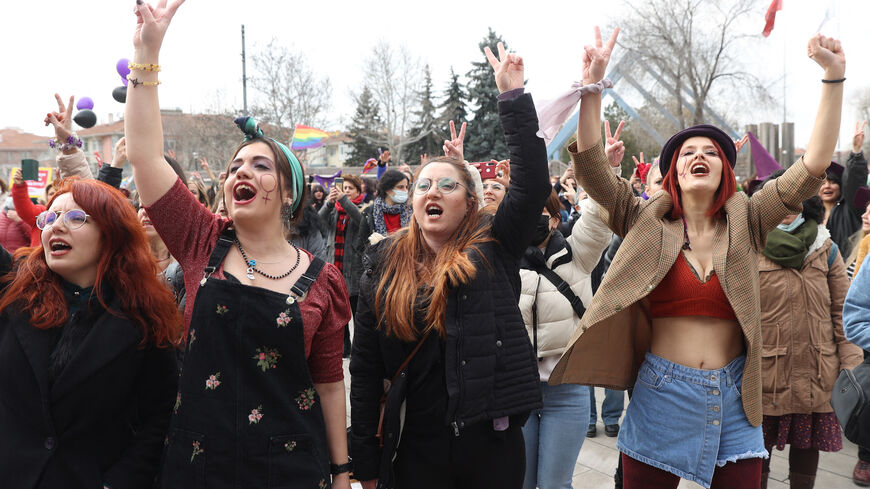 Women gesture as they take part in a protest ahead of the International Women's Day on Sakarya Street in Ankara on March 6, 2022. 