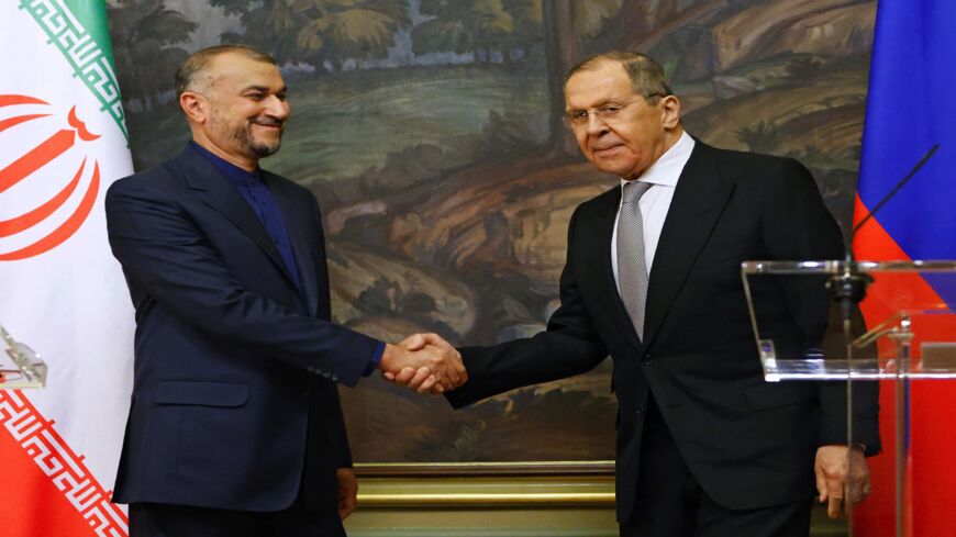 Russian Foreign Minister Sergey Lavrov (R) shakes hands with Iranian Foreign Minister Hossein Amir-Abdollahian