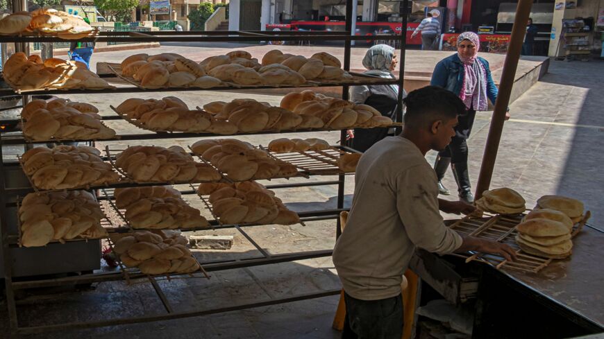 Egyptian men work in a bakery at a market in Cairo, on March 17, 2022. 