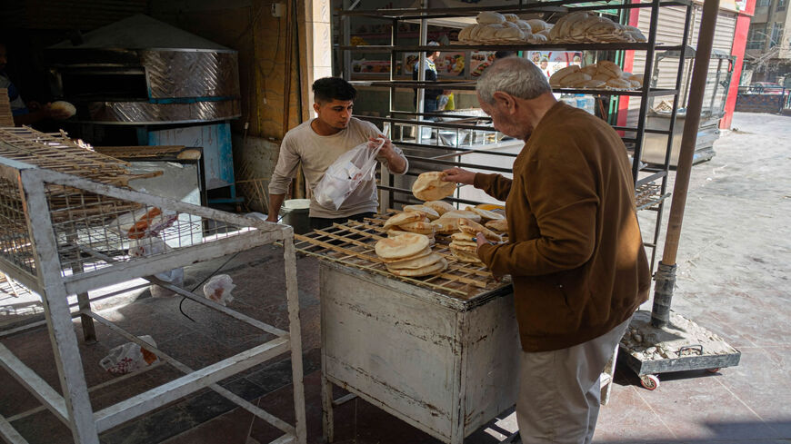 Egyptian men work in a bakery at a market in Cairo, Egypt, March 17, 2022.