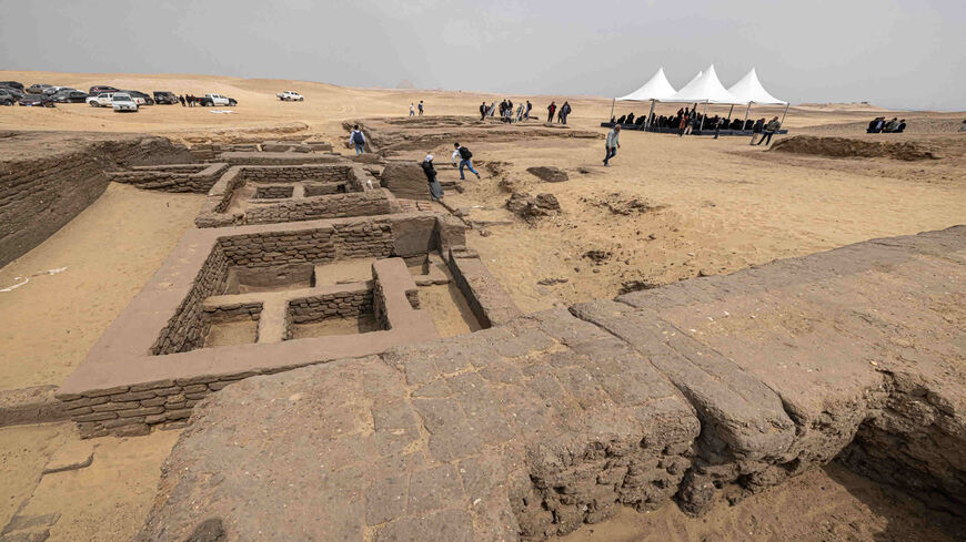 Members of the media gather in the area where five ancient Pharaonic tombs were recently discovered at the Saqqara archaeological site, south of Cairo, Egypt, March 19, 2022.