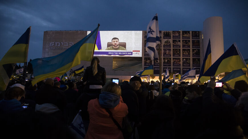 Demonstrators gather to watch Ukrainian President Volodymyr Zelenskyy's speech to the Knesset, broadcast at Habima Square, Tel Aviv, Israel, March 20, 2022.