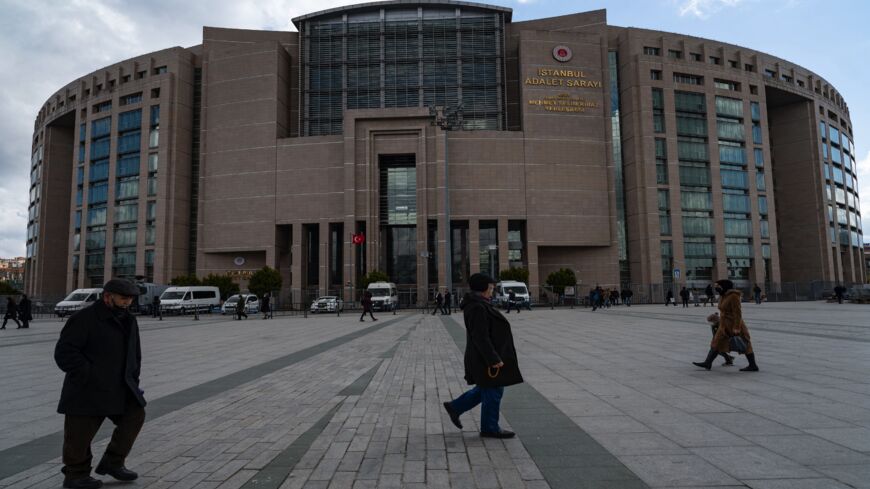 People walk past the Caglayan Justice Palace courthouse in Istanbul on March 21, 2022.