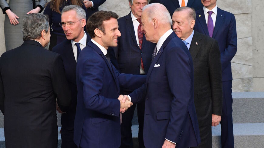 US President Joe Biden shakes hands with France's President Emmanuel Macron (C,L) next to Turkey's President Recep Tayyip Erdogan (R) and NATO Secretary General Jens Stoltenberg (L) at NATO Headquarters in Brussels on March 24, 2022. 