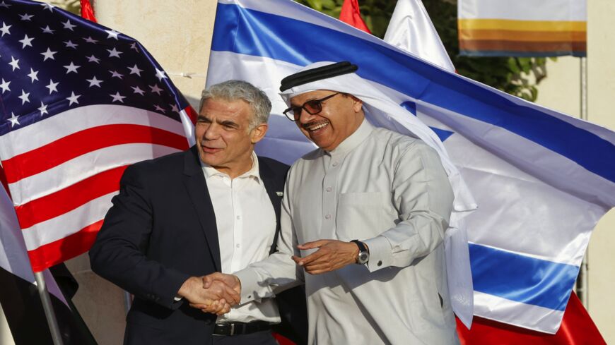 Israel's Foreign Minister Yair Lapid (L) welcomes Bahrain's Minister of Foreign Affairs Abdullatif bin Rashid al-Zayani.