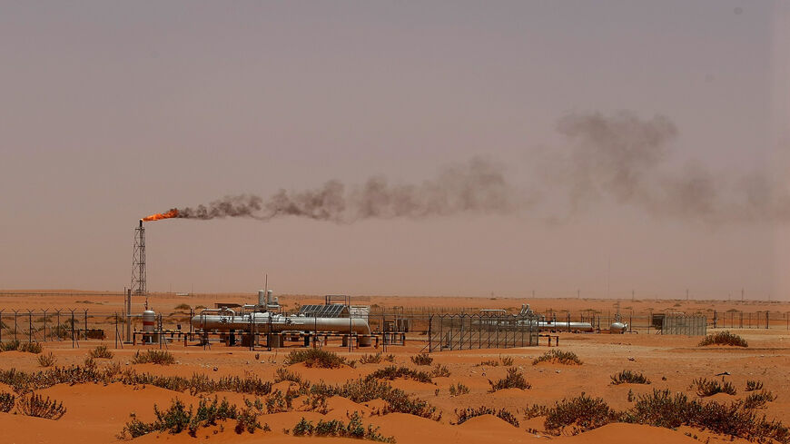 A flame from a Saudi Aramco oil installation known as "Pump 3" is seen in the desert near the oil-rich area of Khouris, 160 kilometers (99 miles) east of Riyadh, Saudi Arabia, June 23, 2008.