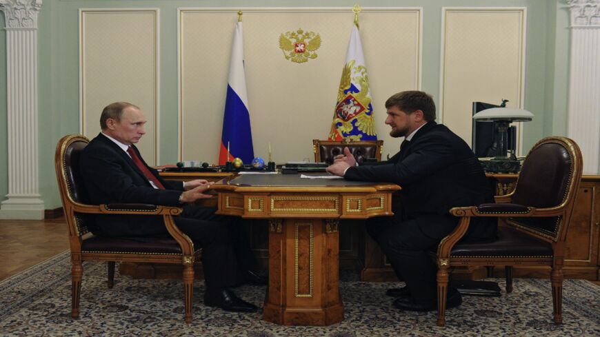 Russia's President Vladimir Putin (L) speaks with Chechnya's head Ramzan Kadyrov.