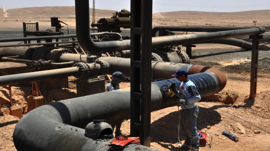A picture taken July 9, 2017, shows workers at Syria's Arak gas field.