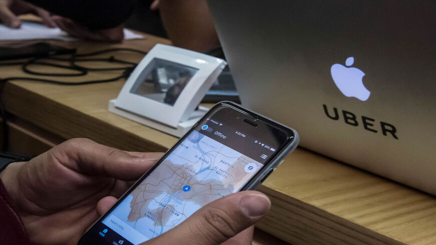 An Uber driver checks his phone application at the company's heardquarters, Cairo, Egypt, Jan. 17, 2018.