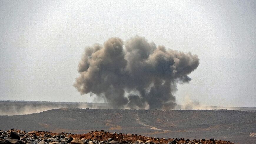 Smoke billows during clashes between forces loyal to Yemen's Saudi-backed government and Huthi rebel fighters in Marib province in March 2021