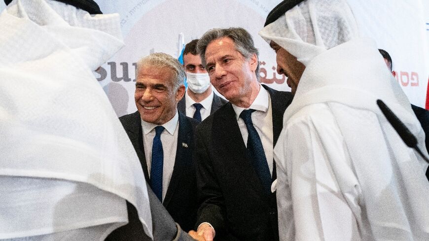 Israel's Foreign Minister Yair Lapid, centre left, and US Secretary of State Antony Blinken shake hands with Bahrain’s Foreign Minister Abdullatif bin Rashid al-Zayani, on the leeft, and UAE’s Foreign Minister Sheikh Abdullah bin Zayed al-Nahyan 