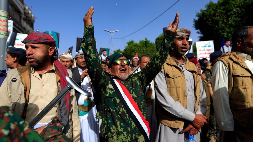 Yemenis loyal to Huthi rebels take part in a rally in the capital Sanaa to mark the seventh anniversary of the Saudi-led coalition's military intervention in their country