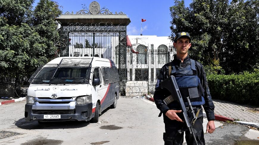 A Tunisian officer stands guard outside parliament in Tunis on March 31