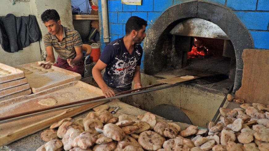 Workers prepare bread at a bakery in the war-torn Yemeni capital Sanaa