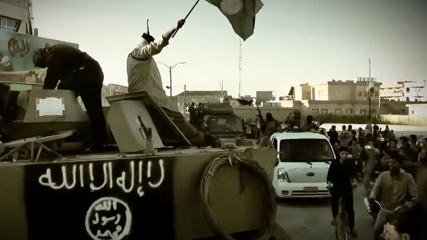 A propaganda video released on March 17, 2014 by the group then called the Islamic State of Iraq and the Levant (ISIL) showing fighters on an armoured vehicle 