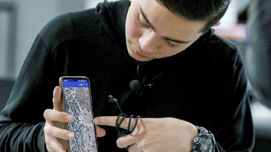 Zain Abu Rumman, an 18-year-old Jordanian student, demonstrates the mobile app for his "SPS Watch" -- a tracking device for the elderly those with special needs that has an eight-day battery life and is resistant to water, heat and breakage