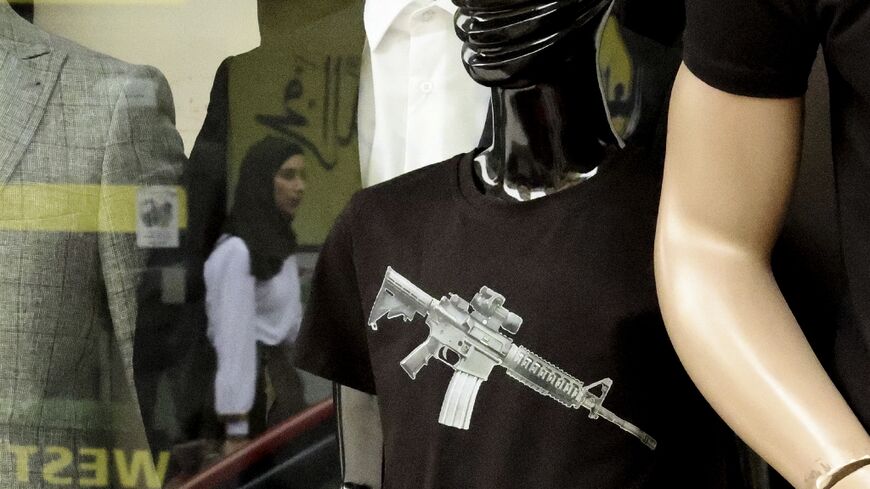 Designer militancy -- shopkeepers in the West Bank say T-shirts emblazoned with an M16 rifle logo have been flying off the shelves as Palestinian consumers display their support for armed resistance in the face of the latest Israeli crackdown