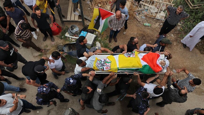 Palestinians carry the body of Ahmed Ibrahim Oweidat, killed during an operation by Israeli forces in the occupied West Bank 