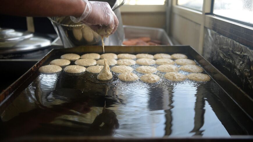 Saleh al-Halwaji prepares saffron and cardamom cakes at the family sweets shop on the outskirts of the Bahraini capital Manama 