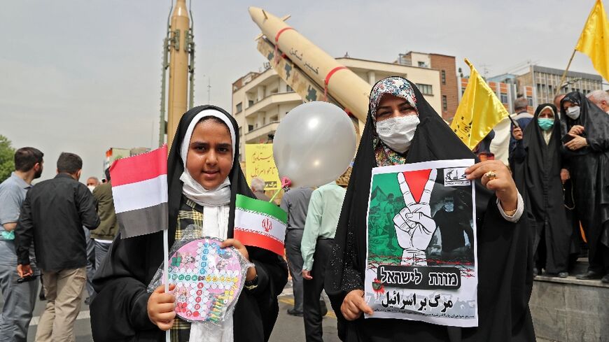 Iranian girls hold a sign reading in Hebrew and Persian, "Death to Israel" during the annual Quds (Jerusalem) Day rally in Tehran in support of the Palestinian people