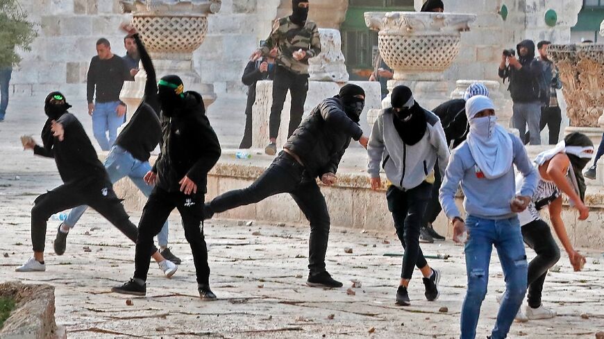 Palestinian demonstrators clash with Israeli police at Jerusalem's Al-Aqsa mosque compound after the morning prayers in east Jerusalem